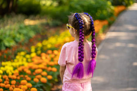 Child with trendy hairstyle, braids with kanekalon on nature backgroundの写真素材