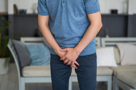Male fertility concept, pain in prostate, man suffering from prostatitis or from a venereal disease at home, urological genital infectionsの写真素材