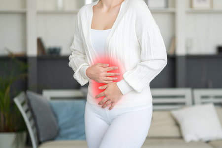 Menstrual pain, woman with stomachache suffering from pms at home, endometriosis, cystitis and other...