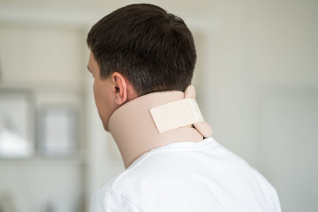 Man wearing a neck brace, cervical orthopedic bandage, health problems concept