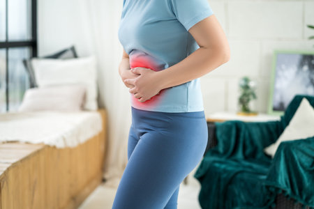 Menstrual pain, woman with stomachache suffering from pms at home, endometriosis, cystitis and other...