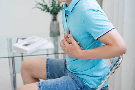 Heart attack, man with chest pain suffering at home, myocardial infarction, health problems concept