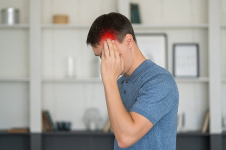 Headache and migraine, man with head pain at home, health problems conceptの写真素材