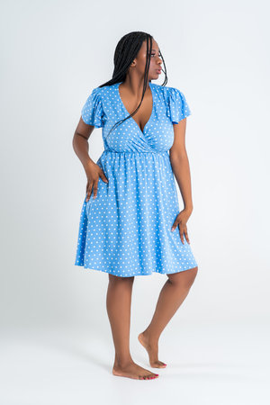 Plus size black sexy model in blue dress, beautiful African woman with curvy figure and pigtailed hairstyle, afro braidsの写真素材