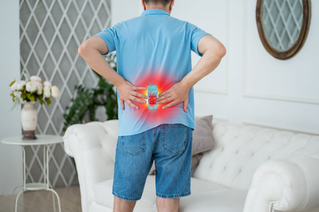 Lumbar intervertebral spine hernia, man with back pain at home, spinal disc disease, painful area...