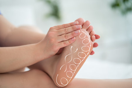 Foot massage, acupressure scheme, corns and calluses on feet, dry skin on legs, cracked heels, barefoot woman relaxing on sofa at homeの写真素材