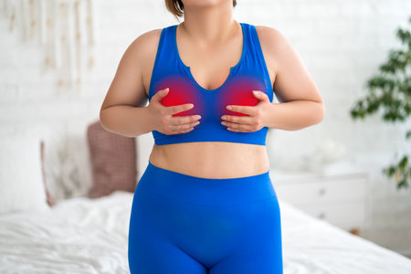 Breast test, woman in blue bra examining her breasts for cancer at home, mastitis ore mastopathy disease, health problems conceptの写真素材