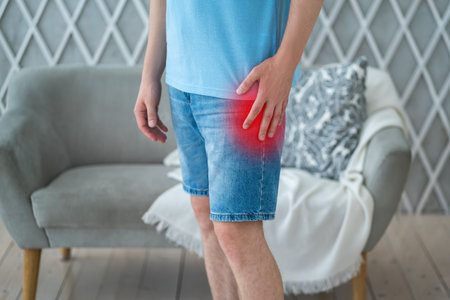 Hip pain, man suffering from osteoarthritis at home, health problems conceptの写真素材
