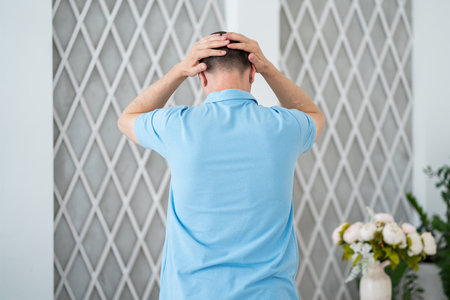 Headache and migraine, man with head pain in home, health problems conceptの写真素材
