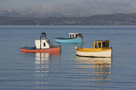 3 colourful fishing boats