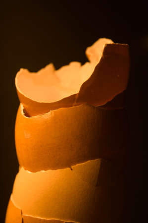 A towering stack of eggshells in the darkの写真素材