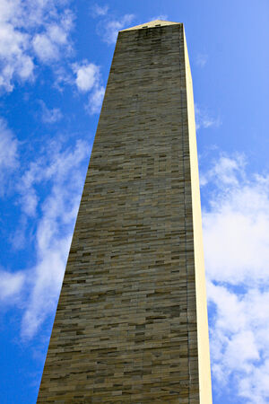 A view of the Washington Monument in Washington, D.C. from its base towards a beautiful blue sky with light fluffy clouds.の写真素材