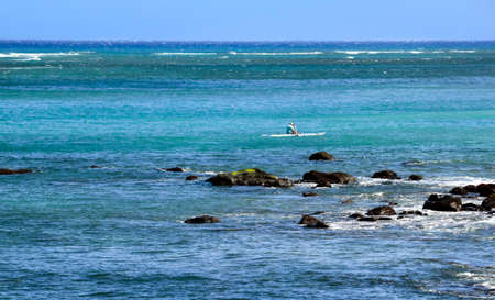 Lone kayak on the Pacific off the rocky coast of Mauiの写真素材