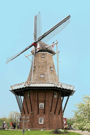 A Dutch windmill in Western Michigan with tourists and character actors depicting the culture of the setting.の写真素材