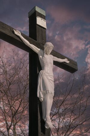 A monument to the crucifixion of our Lord against a twilight skyの写真素材