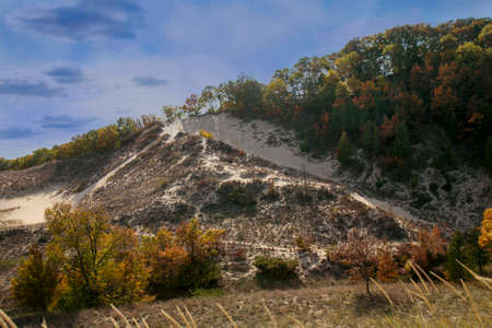 Mount Randall is cloaked in the beauty of her fall colors, on the shores of Lake Michigan, at Warren Dunes State Park in Michiganの写真素材
