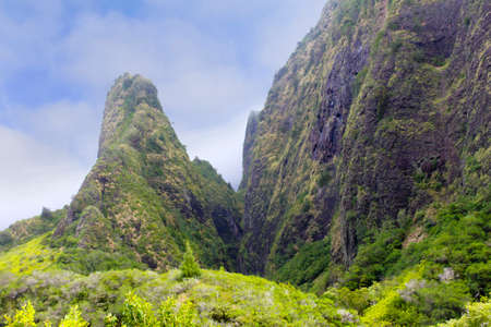 The majesty of the Needle stands out against a gentle blue sky with wispy clouds.  In Iao Valley, Maui, Hawaii.の写真素材