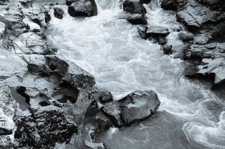 Water flowing over rocks, black and white. Beautiful nature background.の写真素材