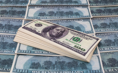 Dollars banknotes on the background of hundred dollar bills.