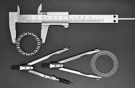 caliper, two compasses and two bearings on a black backgroundの写真素材