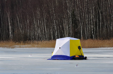 Winter fishing on the lake frozen. Camping on the ice.