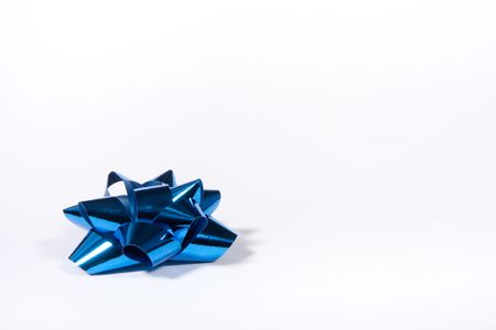 Blue Shiny Gift Bow isolated against white background from low viewpoint.の写真素材