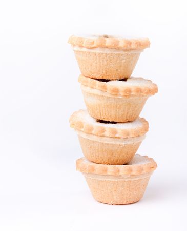 Tower of sugared Sweet Mince Pies against plain white background.の写真素材