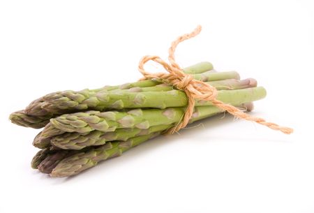 Asparagus spears tied with hemp or sisal string keeping them tidy isolated against white.の写真素材