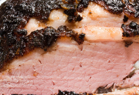 Home roasted and sliced Caribbean jerk Ham Roast with focus on the sticky glaze.の写真素材