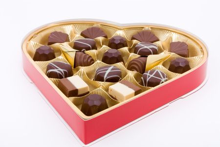 Heart shaped box of Valentine Chocolates against white background.の写真素材