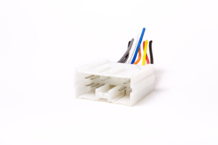 Multi pin car audio DIN connector isolated against white background.