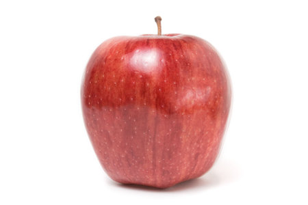 Shiny Red Delicious apple isolated against white background.