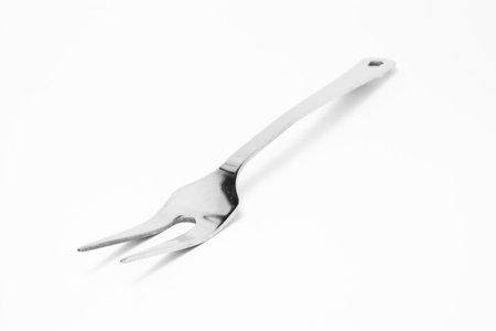 Large stainless steel Fork, Kitchen Utensil isolated against white background.