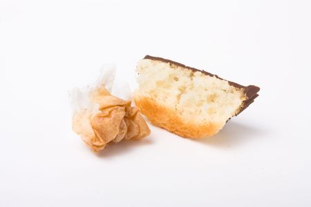 Chocolate topped sponge cup cake isolated against white background.の写真素材
