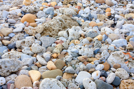 Pebble beach background/textue image of different sizes and shapes of sea washed rocks.