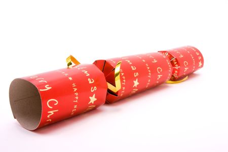 Red Christmas Cracker shot from low viewpoint with shallow focus against white background.の写真素材