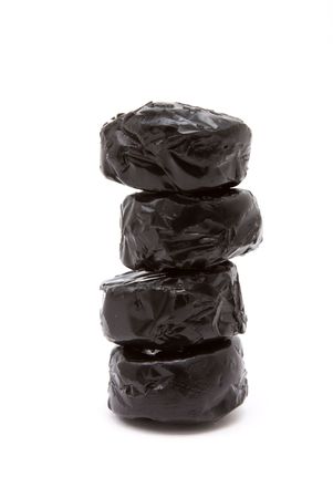 Black shiny Licquorice Toffee isolated against white background.の写真素材