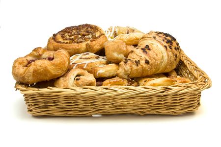 Wicker basket with selection of French & Danish pastries on white background.の写真素材