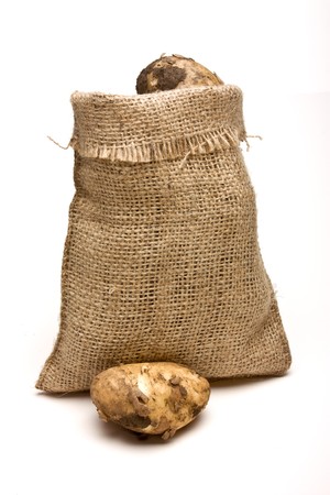 Sack of new Potatoes from low perspective isolated against white background.の写真素材