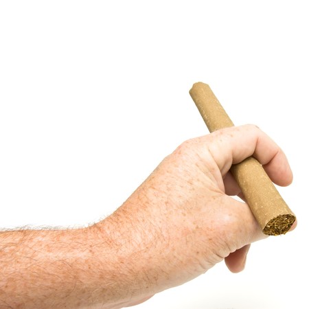 male hand holding Large fat cigar isolated on white background.の写真素材