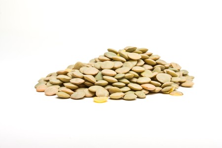 Pile of green lentils from low perspective isolated on white.の写真素材