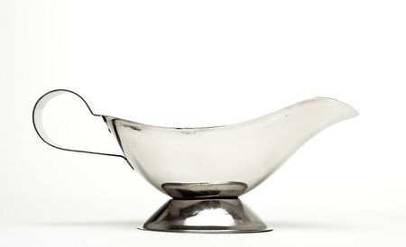 Shiny silver Gravy Boat from low perspective isolated against white.の写真素材