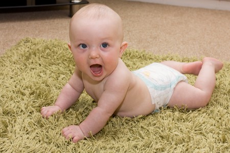 Adorable expresive happy baby boy from low perspective.の写真素材
