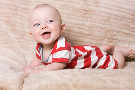 Adorable expresive happy baby boy from low perspective.の写真素材