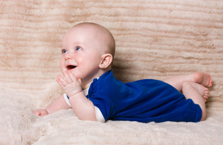 Adorable expresive happy baby boy from low perspective.