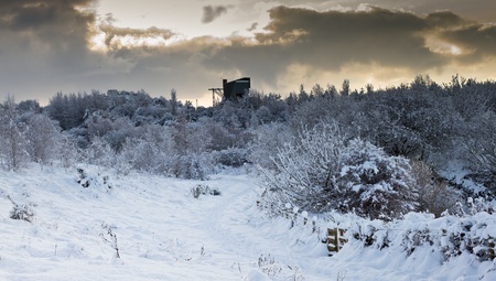Picturesque winter scenic of thick covering of snow and industrial building.の写真素材