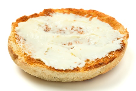 Hot toasted english muffin with butter isolated on white.の写真素材