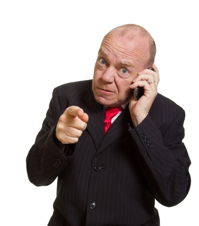 Expressive senior businessman isolated on white pointing finger conceptの写真素材