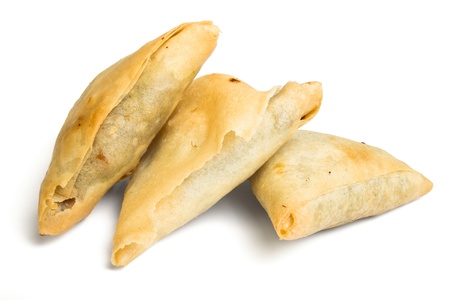 Cooked golden Samosa's from low perspective isolated on white.の写真素材