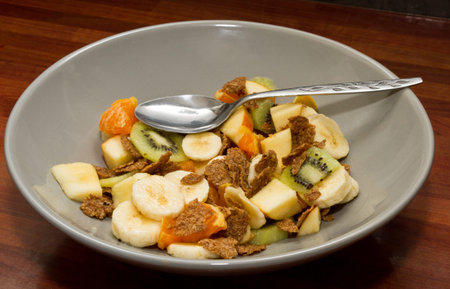 Vibrant fresh Fruit salad and bran flakes.